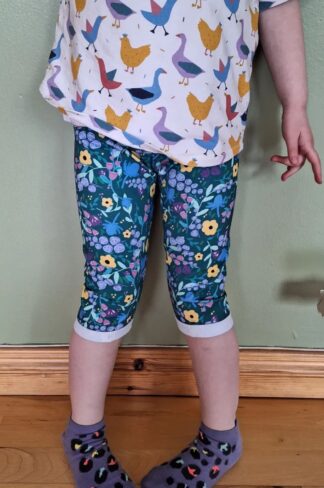 child wearing cropped Grow With Me leggings in Watt a Floral design, paired with Chickadee Grow With Me dolman tshirt